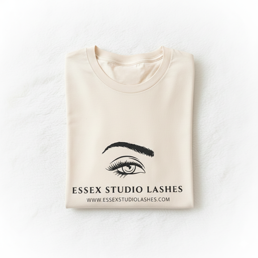 Folded beige sweatshirt with 'Essex Studio Lashes' logo on a white background