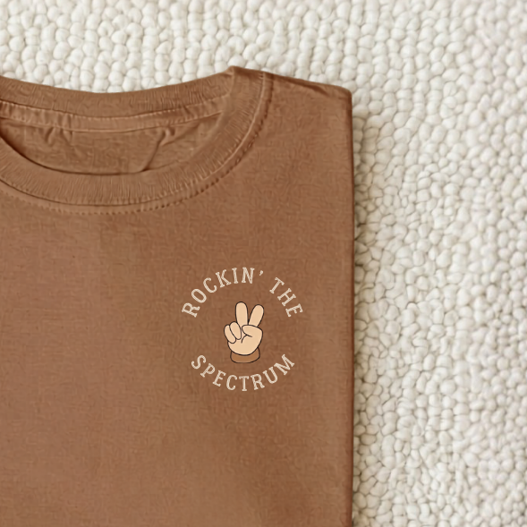 Kids “Rocking The Spectrum” t-shirt featuring retro-inspired inclusion design, soft cotton autism awareness clothing for children