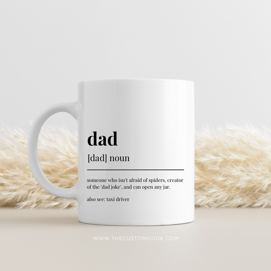 White mug with a definition of 'dad' on a light background