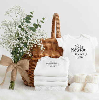 Baby shower gift set with white shirts and a basket on a white background