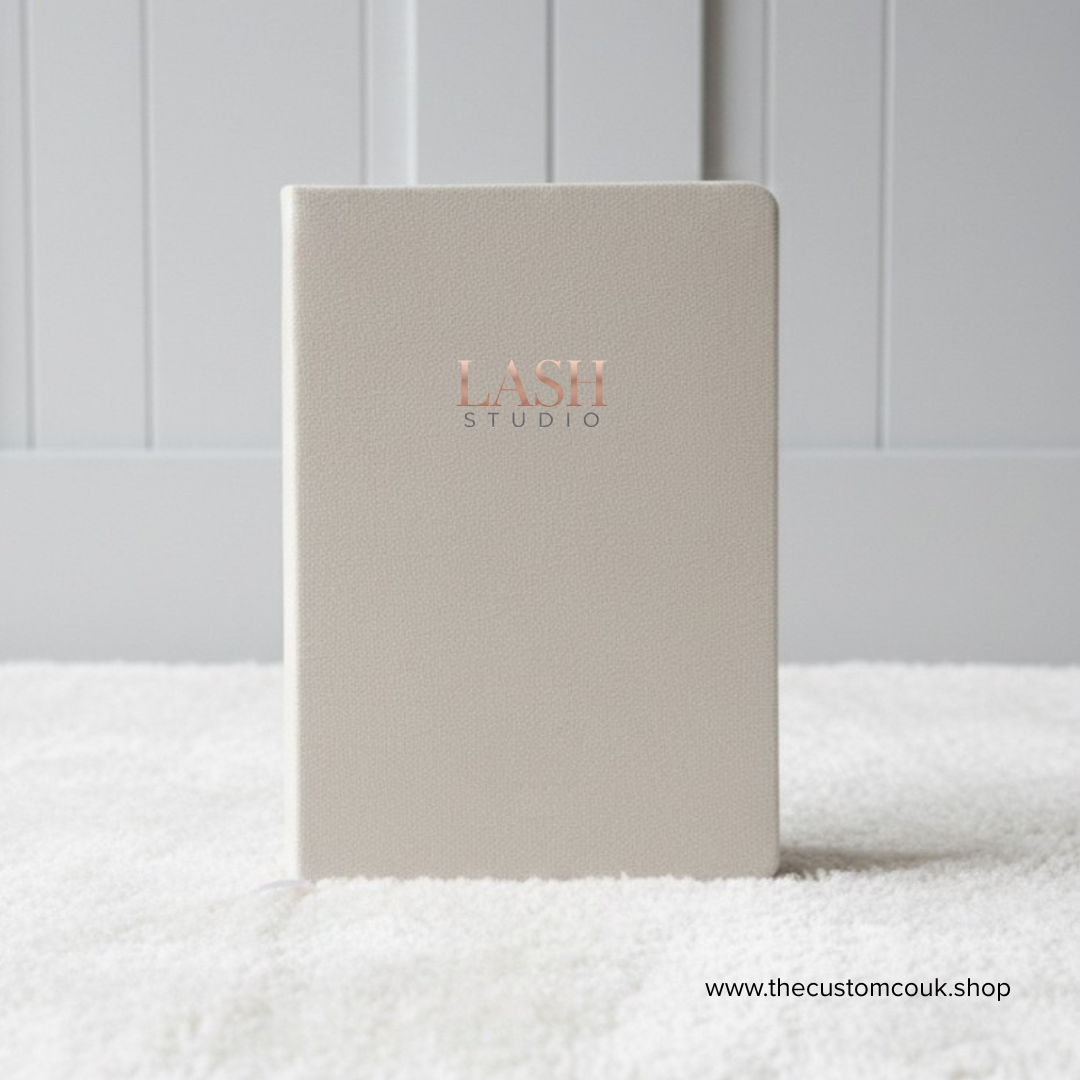 Custom branded A5 velvet notebook with logo and lined pages.