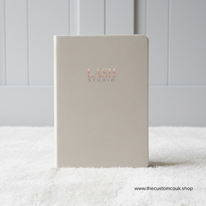 Custom branded A5 velvet notebook with logo and lined pages.