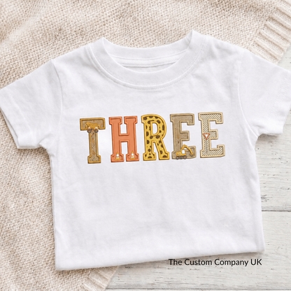 Custom construction birthday t-shirt with 'THREE' printed in embroidered letters.