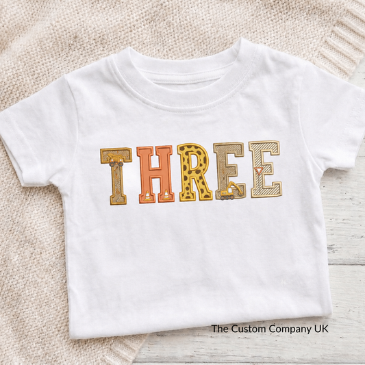 Custom construction birthday t-shirt with 'THREE' printed in embroidered letters.