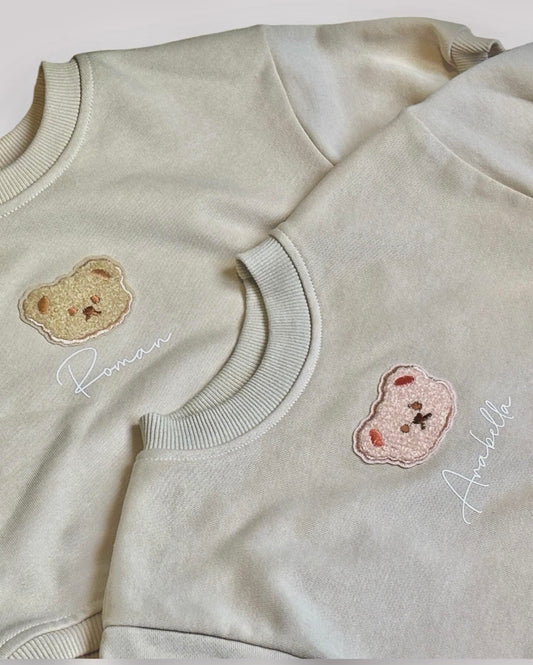 Personalised teddy bear romper sweater with embroidered bear design and custom baby name.