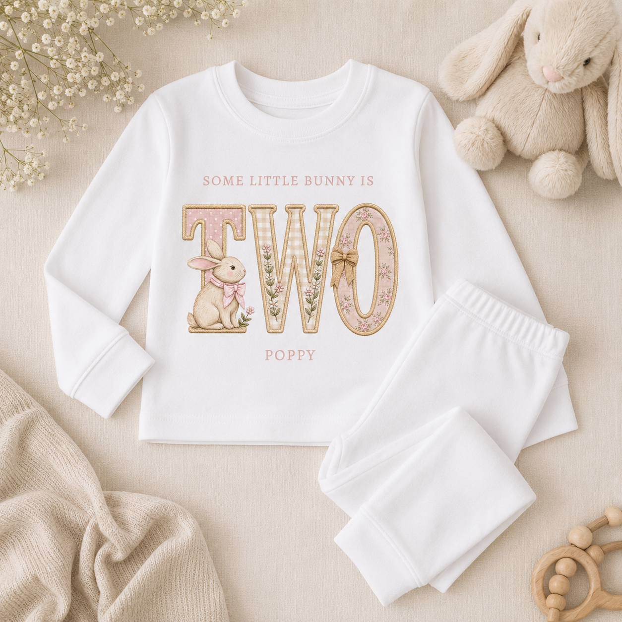 Personalised white children’s pyjama flat lay with embroidered bunny birthday design and custom name detail