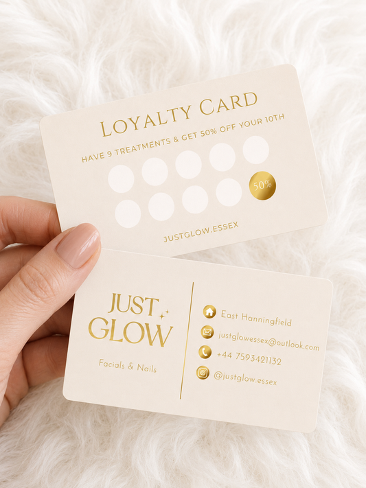Loyalty card from Just Glow held by a hand on a white fur background