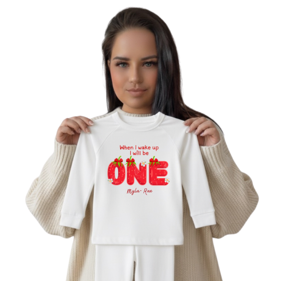 Owner holding a white shirt with custom design