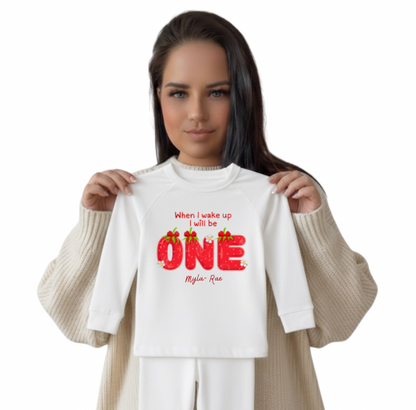 Owner holding a white shirt with custom design